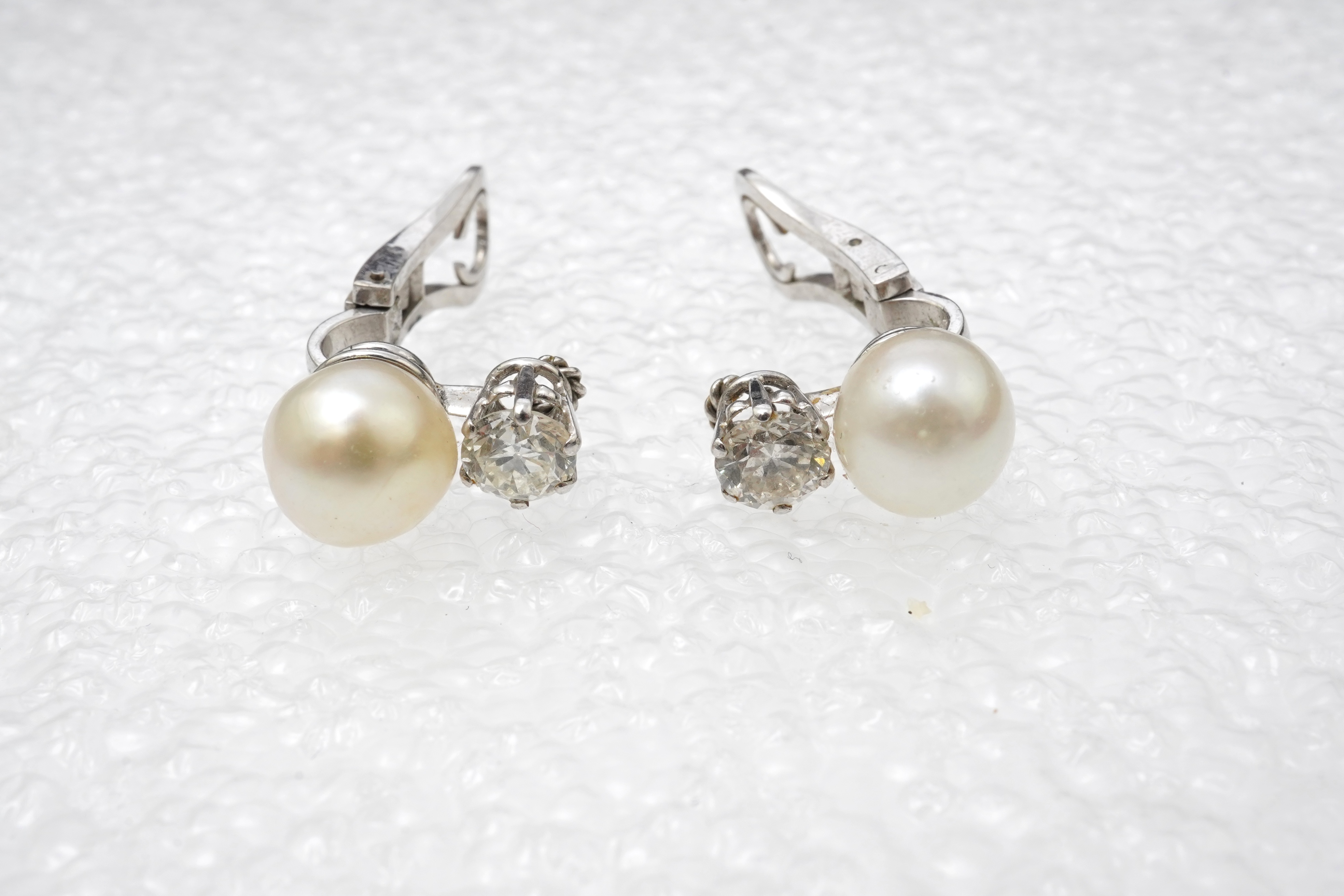 A pair of pearl and diamond ear clips, mid 20th century